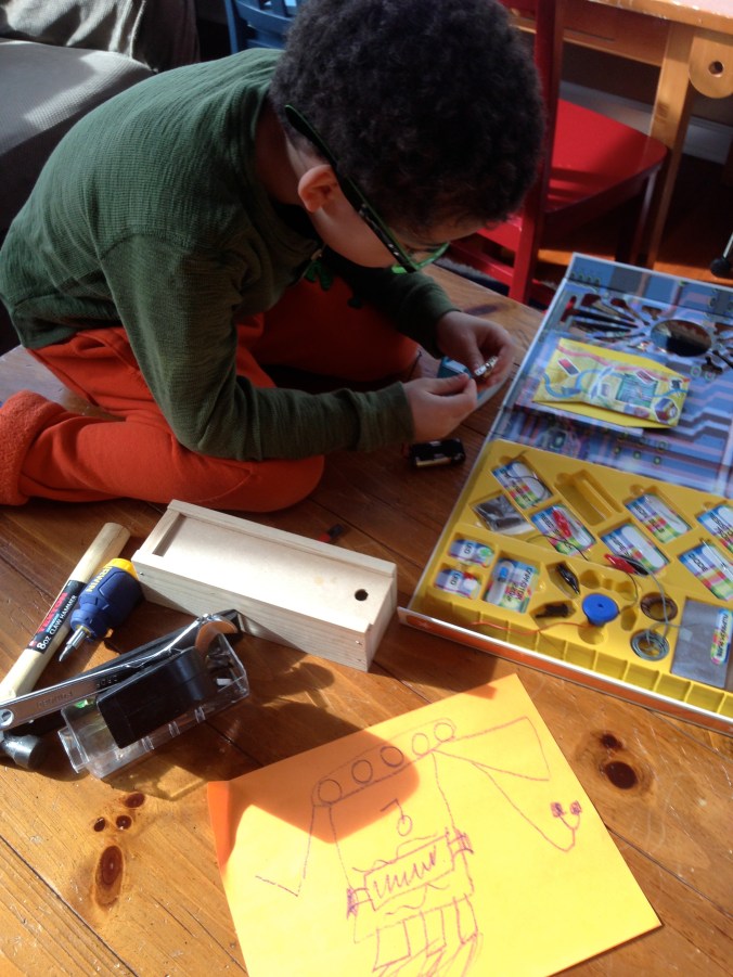 The boy busily doing his own thing.